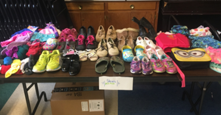 Picture of shoes on a table for a textile redistribution event at LaFayette elementary school.